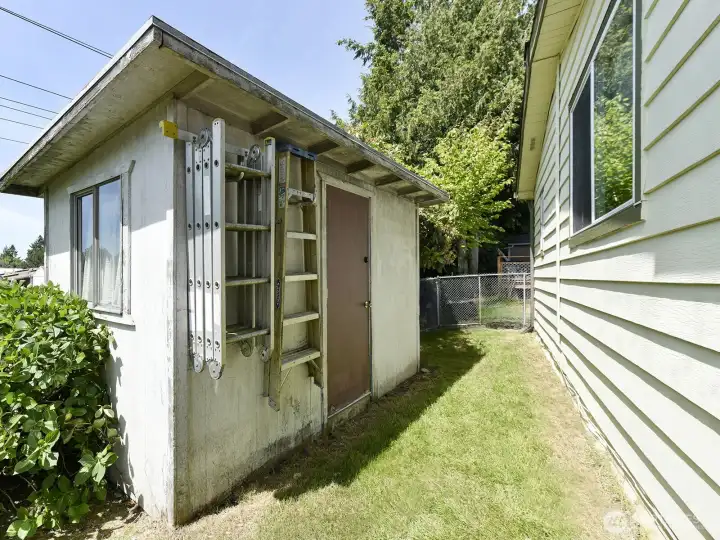 There is a garden shed at the very back of the yard space for yard tools and extra storage.