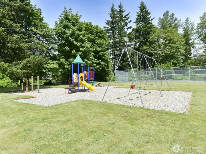 The park is equipped with playground play area, including swings, tetherball, tennis/pickleball court, basketball court, and picnic areas.