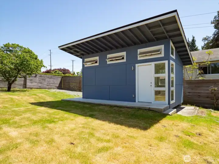 Large Detached Outbuilding Featuring Flexible Office Space, Half Bath, and Sink