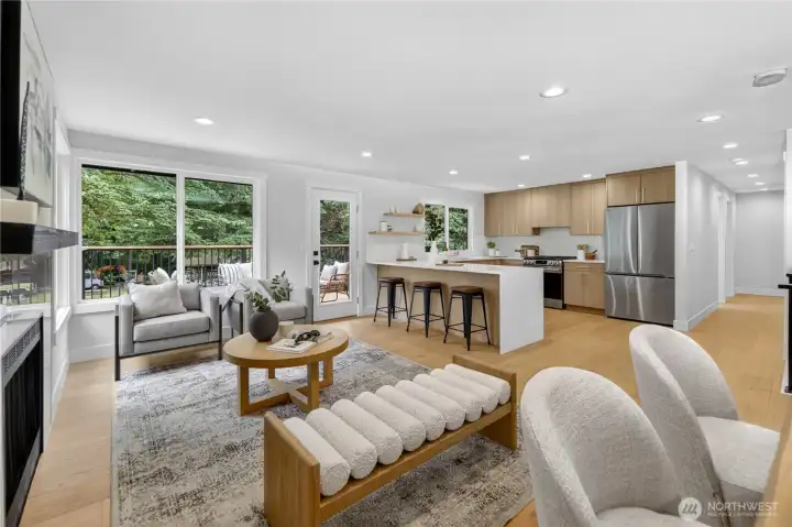 Large windows in the main living area draw in beautiful natural light all day and frame lovely views of the surrounding trees, while the door opens directly to the new expansive deck in the private back yard. The result is an easy, inviting connection between indoor living and the peaceful outdoor setting. As the day winds down, the southern exposure brings soft evening color into the room, with warm amber, lavender, and coral tones filtering through the trees. All windows throughout the home are new double-pane storm windows, adding comfort and efficiency. Large windows in the main living area draw in beautiful natural light all day and frame lovely views of the surrounding trees, while the door opens directly to the new expansive deck in the private back yard. The result is an easy, inviting connection between indoor living and the peaceful outdoor setting. As the day winds down, the southern exposure brings soft evening color into the room, with warm amber, lavender, and coral tones filtering through the trees. All windows throughout the home are new double-pane storm windows, adding comfort and efficiency.