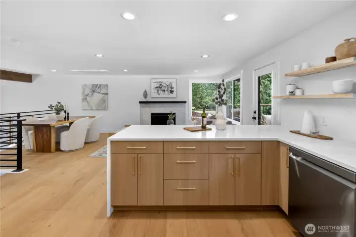 The open-concept design keeps the kitchen beautifully connected to the family room, so the cook can stay part of the conversation instead of feeling tucked away. From meal prep to cleanup, the heart of the home remains open, social, and connected, with views across the dining and living areas and out toward the trees. The open-concept design keeps the kitchen beautifully connected to the family room, so the cook can stay part of the conversation instead of feeling tucked away. From meal prep to cleanup, the heart of the home remains open, social, and connected, with views across the dining and living areas and out toward the trees.