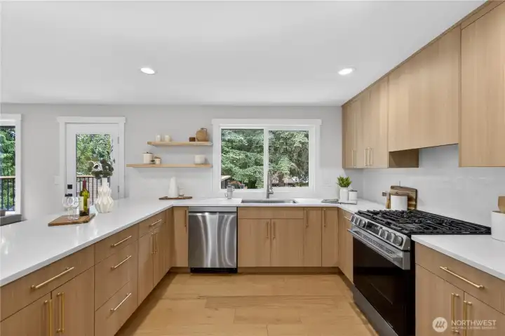 Even the daily task of doing dishes feels lifted here, with a large window over the sink bringing in green garden views and a sense of lightness to the routine. A graceful swan-neck faucet with easy sprayer, double sink, convenient dishwasher placement, and garbage disposal all help the work flow more smoothly. The dishwasher and all kitchen appliances are new LG, adding to the fresh, updated feel. Quartz counters and backsplash add beauty all around and make cleanup easier, turning an ordinary chore into something that feels far more pleasant. Even the daily task of doing dishes feels lifted here, with a large window over the sink bringing in green garden views and a sense of lightness to the routine. A graceful swan-neck faucet with easy sprayer, double sink, convenient dishwasher placement, and garbage disposal all help the work flow more smoothly. The dishwasher and all kitchen appliances are new LG, adding to the fresh, updated feel. Quartz counters and backsplash add beauty all around and make cleanup easier, turning an ordinary chore into something that feels far more pleasant.