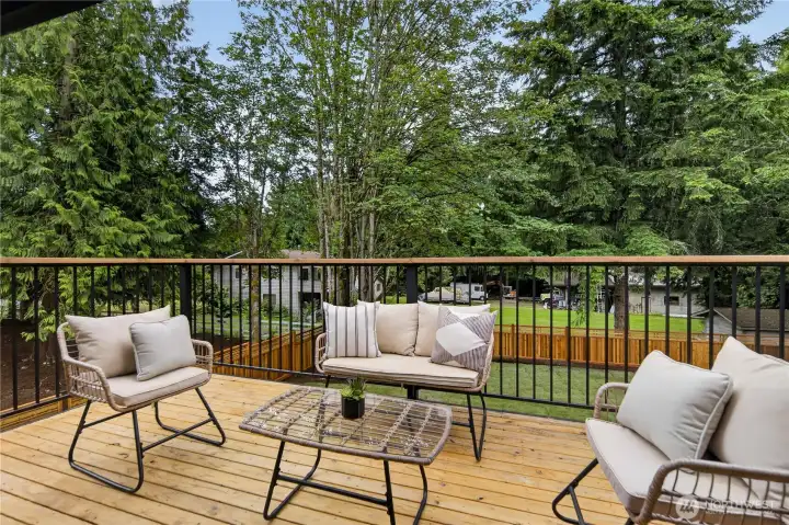 Just off the main living room, the new balcony connects indoor and outdoor living with ease through new sliding glass doors. Matching railings continue the home’s clean modern style, while lovely views across the private back yard and into the treetops create a quiet treehouse feeling surrounded by trees and birdlife. Its easy access from the kitchen and dining area also makes it a wonderful spot for those who love to barbeque. Watch lovely sunsets from your south facing perch change the landscape to glowing warm hues. With its sunny southern exposure, it is a beautiful place to watch evening colors settle into the sky in shades of gold, peach, and rose beyond the trees. Just off the main living room, the new balcony connects indoor and outdoor living with ease through new sliding glass doors. Matching railings continue the home’s clean modern style, while lovely views across the private back yard and into the treetops create a quiet treehouse feeling surrounded by trees and birdlife. Its easy access from the kitchen and dining area also makes it a wonderful spot for those who love to barbeque. Watch lovely sunsets from your south facing perch change the landscape to glowing warm hues. With its sunny southern exposure, it is a beautiful place to watch evening colors settle into the sky in shades of gold, peach, and rose beyond the trees.