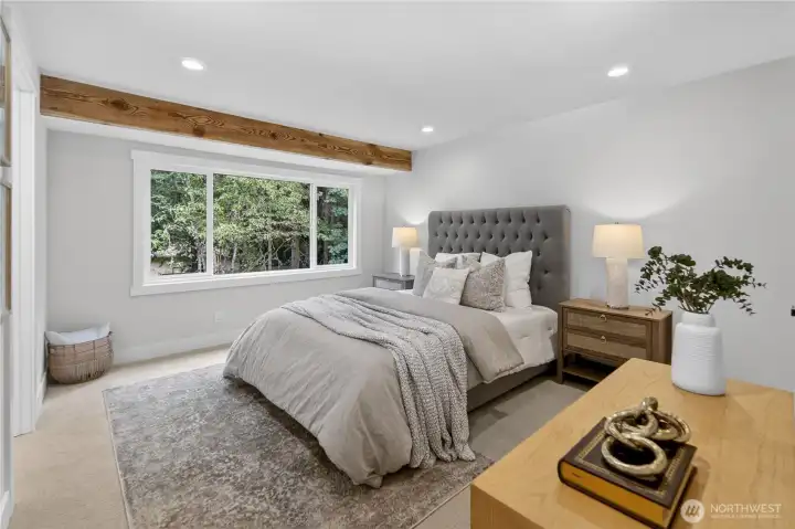 The primary bedroom feels calm and restful, with new carpet, soft off-white walls that will work beautifully with any style, and bright white trim that gives the room a crisp, elevated finish. Warm recessed lighting provides an even, gentle glow, while the exposed ceiling beam adds natural texture and a quiet sense of Northwest warmth. The primary bedroom feels calm and restful, with new carpet, soft off-white walls that will work beautifully with any style, and bright white trim that gives the room a crisp, elevated finish. Warm recessed lighting provides an even, gentle glow, while the exposed ceiling beam adds natural texture and a quiet sense of Northwest warmth.