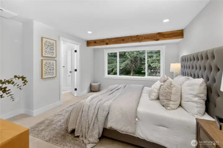 A large south-facing window looks out toward the back yard and surrounding trees, bringing in natural light by day and a soft evening glow as the sun begins to set. With room for a king-size bed, large sets of drawers, and a spacious walk-in closet, the primary bedroom offers the comfort, storage, and easy livability a true retreat should have. A large south-facing window looks out toward the back yard and surrounding trees, bringing in natural light by day and a soft evening glow as the sun begins to set. With room for a king-size bed, large sets of drawers, and a spacious walk-in closet, the primary bedroom offers the comfort, storage, and easy livability a true retreat should have.