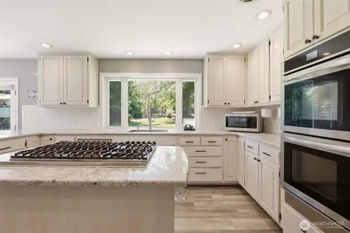 Double oven Chef style gas stove top - a lot of natural light into the kitchen