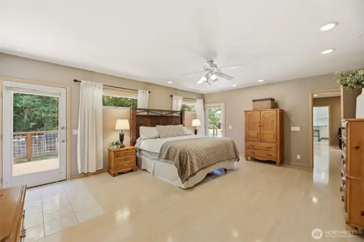 Primary Bedroom - Entry from the family room with Doors to the back deck and a door to the side covered deck
