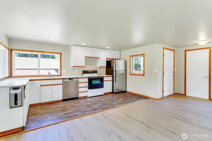 Kitchen view with main entry and coat closet far right.