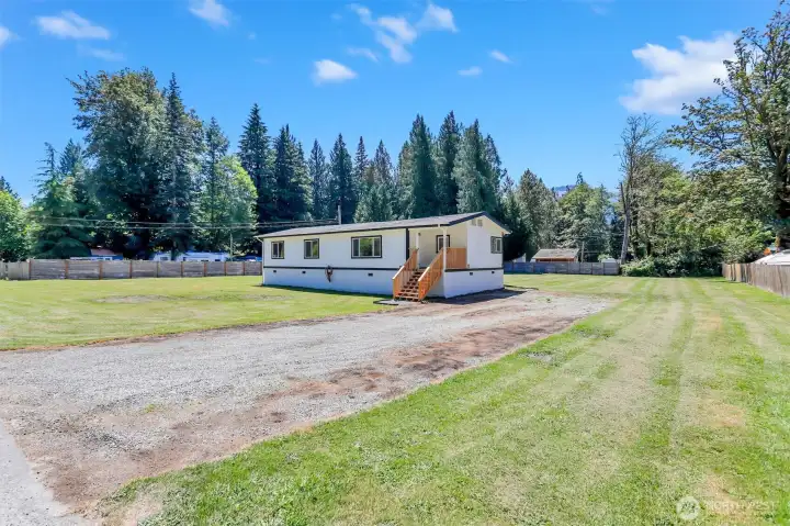 The opposite front corner of the property on the driveway side.