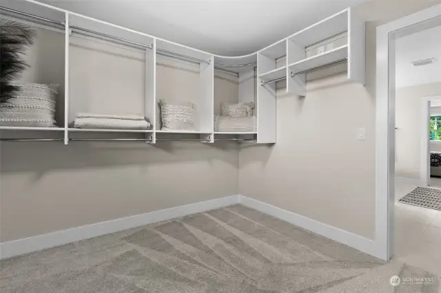 Custom built shelving in the primary walk in closet will keep your life organized.