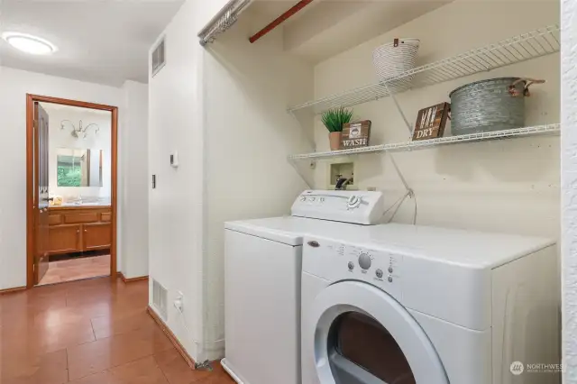 Laundry closet in hallway, with shelving. Washer and dryer convey! (Buyer can easily add doors or curtain, if desired)