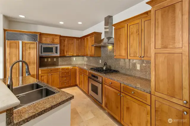 Kitchen boosts gas cooktop, and electric oven. Built-in microwave, granite countertops with back splash.  Large pantry for storage and side by side Sub Zero.