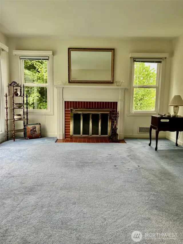 Great view of the living room with the head on view of the beautiful bricked fireplace and beautiful mantle