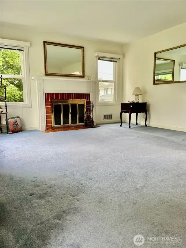 The stunning fireplace wall, along with the beautiful fireplace and mantle also has two great side windows that along with the wall of windows in the front of the room help flood the livingroom with natural light