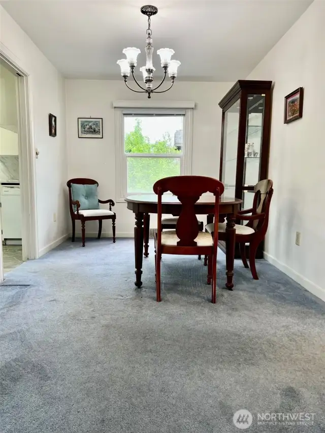 Large window in the dining room gives a great light to the space.  The doorway shown is the entry to the kitchen