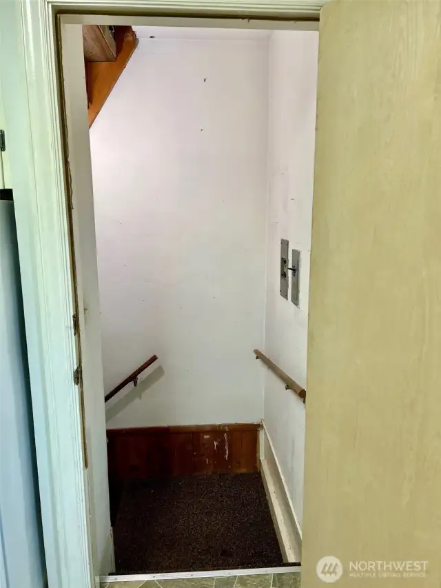 Landing at the top of the stairs from garage & shop space that lead  to the kitchen and the home's wonderful living areas
