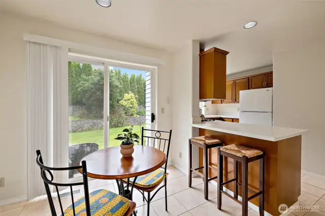 Slider leads to back patio and sprawling lawn that wraps around.