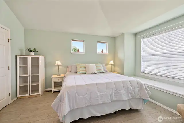 Vaulted ceilings in the primary enhance the space.