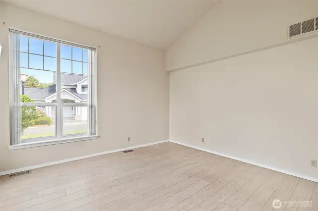 Enter the spacious living room with expansive windows that fill the room with natural light.