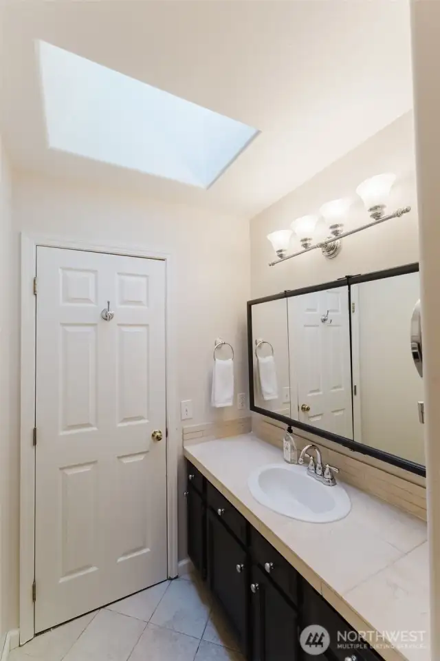 Second view of primary bath with skylight.