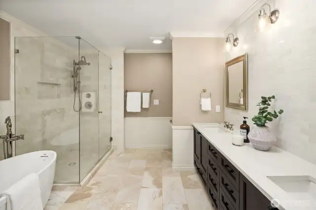 The jewel in the crown: A stunningly updated primary bathroom with marble floors and wall tile