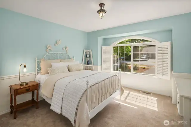 One of two secondary bedrooms in this wing of the house, with plantation shutters.