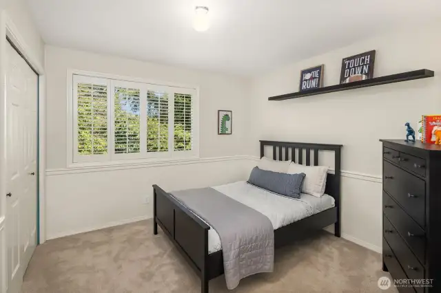 One of two secondary bedrooms, with plantation shutters, walk-in California Closets