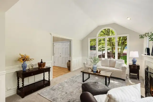 Vaulted ceilings and a gorgeous window overlooking mature landscaping make this room so very special. It's filled with sunlight and a wonderful place to relax or entertain.