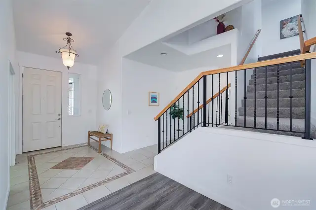 Beautiful ceramic tile design in entry with Vaulted ceilings for a spacious feeling.