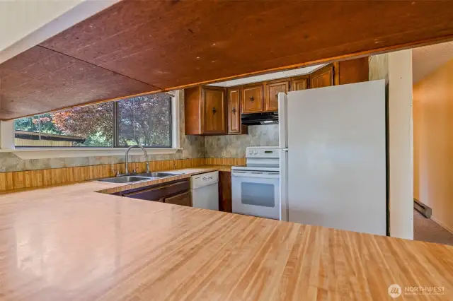 Kitchen eating bar open to dining area