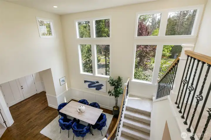 Dramatic center area with double story open staircase and wall of windows.