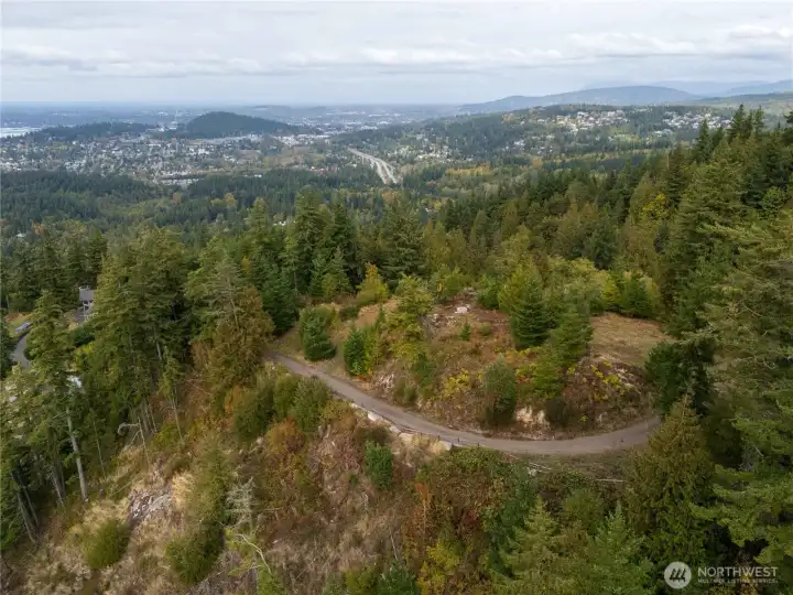 A view looking North showcasing the private drive winding up in elevation accessing the build site.