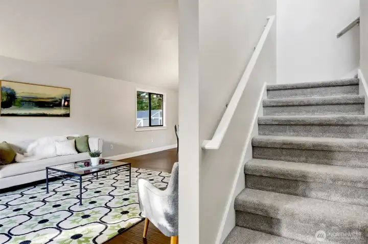 Living room to your left and the stairs to three bedrooms.