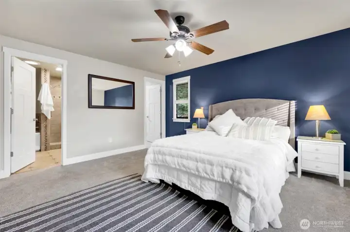Primary bedroom with the walk-in closet to the right and the ensuite on the right.