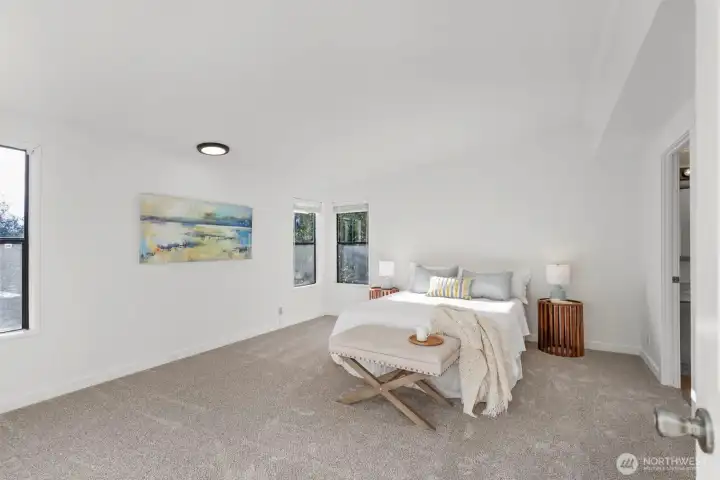 Large primary suite with a walk in closet, and private bath with soaking tub, shower, and double vanity.