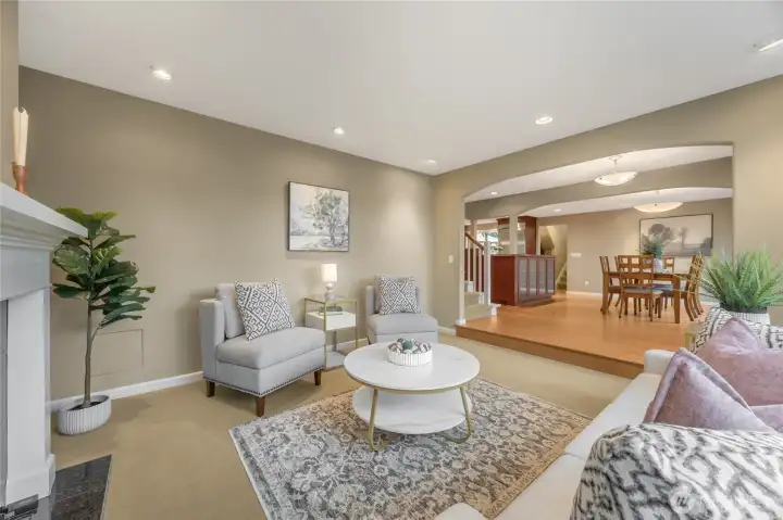 From the living room you can see into the kitchen, the dining room and way in the back you can spy the second staircase going up to the ensuite bedroom 4