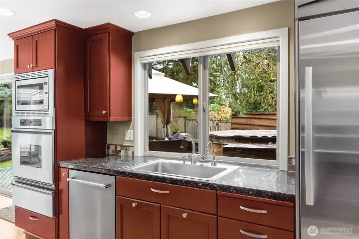 The counters are granite tile, the appliances are stainless steel and the cabinets are Carrass