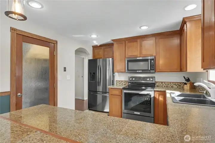 Kitchen view 2 from dining, love the breakfast bar, arched doorways and large pantry to your left!