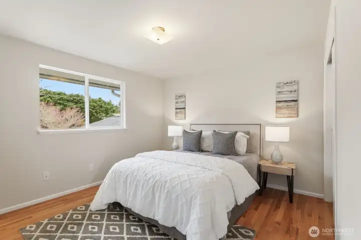 Primary bedroom on the upper floor with private half bath.