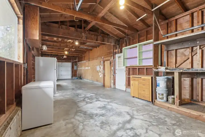 The garage is HUGE! This angle is looking from the back to the front garage door. There is also a full size garage door at the back of the garage. Perfect for the home mechanic, woodworker, artist, hobbyist, or home based business.