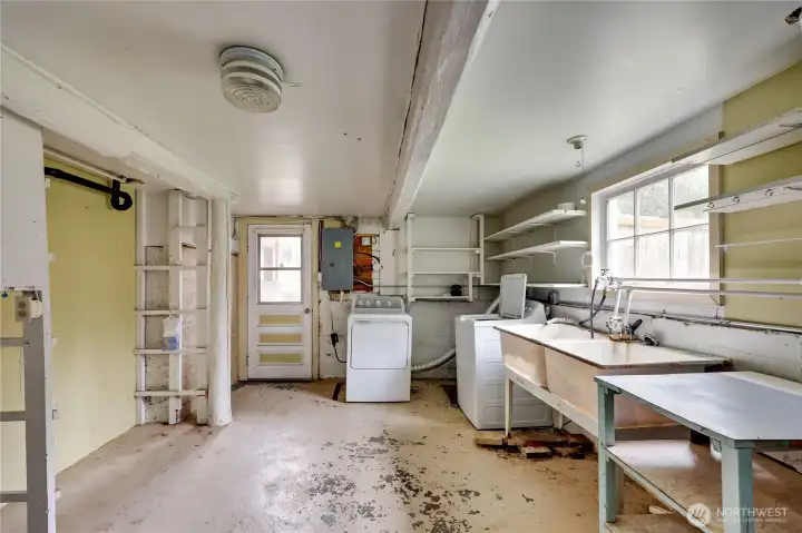 Laundry in basement with outside door