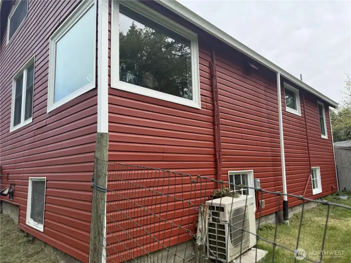 Back of home with Mitsubishi heat pump