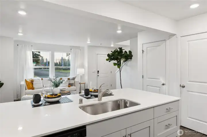 Light-filled kitchen island offering extra seating, prep space, and a natural gathering spot. Photos are for representational purposes only, colors, elevation and features may vary.