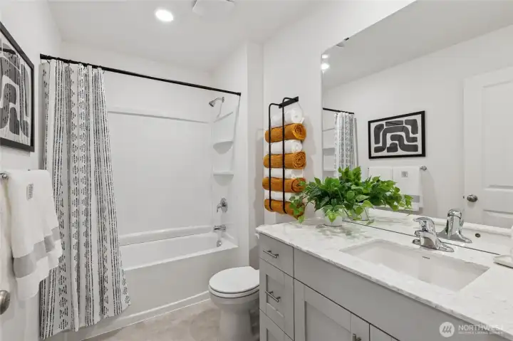 Full bath with tub and quartz countertops. Photos are for representational purposes only, colors, elevation and features may vary.