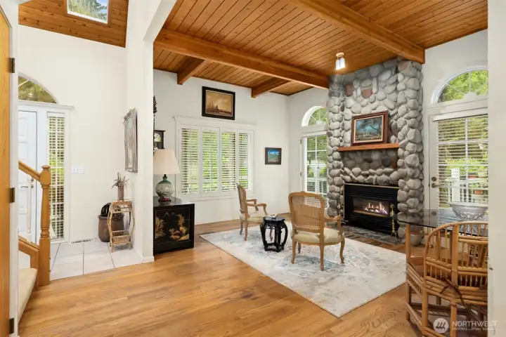 Inside you will find the cozy den with hardwood floors, river rock fireplace and wood decked ceiling.