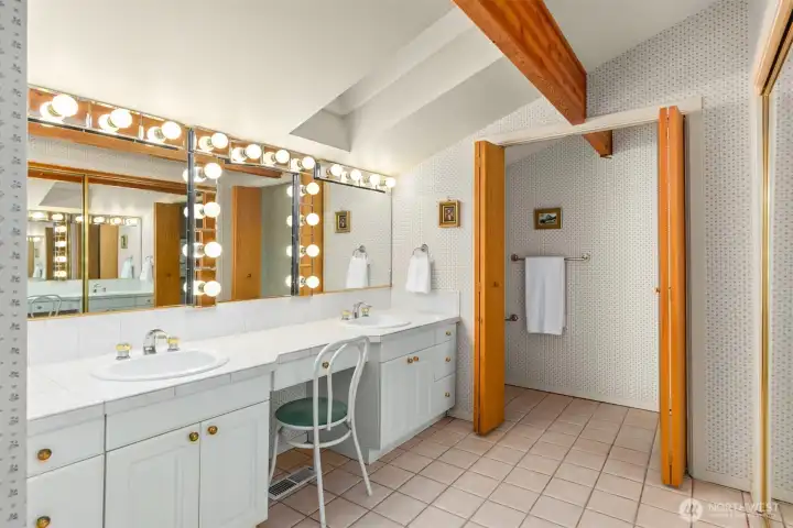 A large closet to the right allows for plenty of storage, there is also a linen closet out of view. The private toilet and shower are through the wood bi-fold doors.