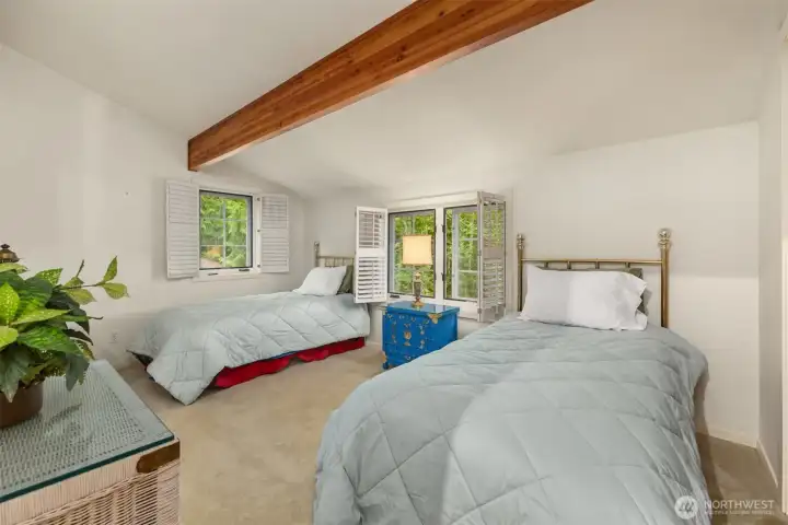 The 3rd upper level bedroom also has vaulted ceiling an two windows with wood shutters overlooking the lovely back yard.