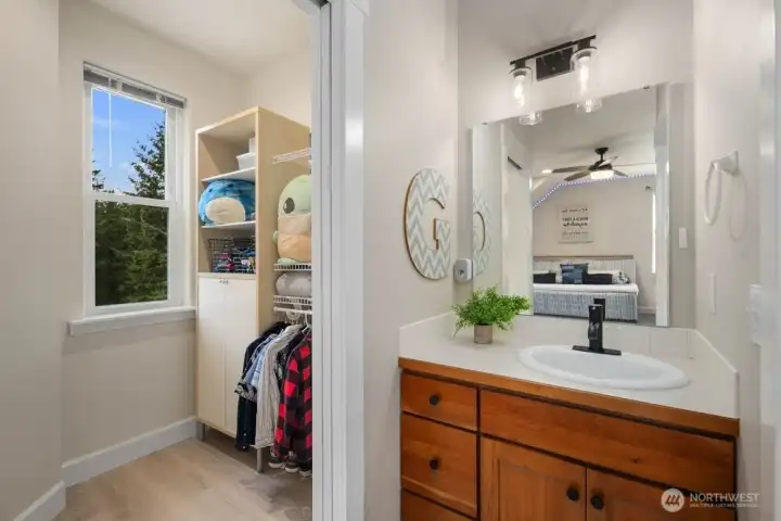 Jack and Jill bath serving large bedrooms w/private sinks and walk-in closets