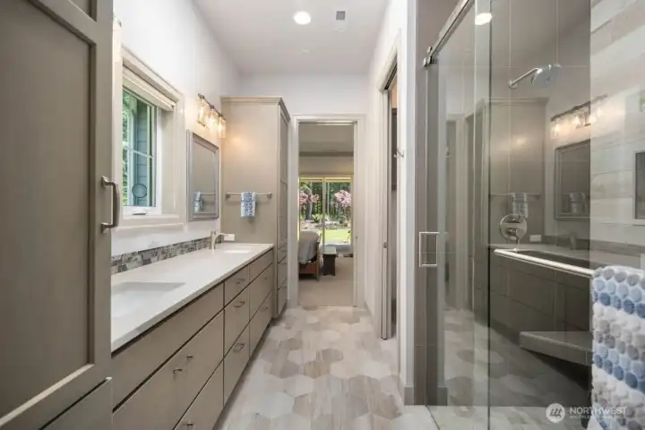 Primary bath retreat w/large walk-in shower, dual shower heads and a massive walk-in closet just beyond