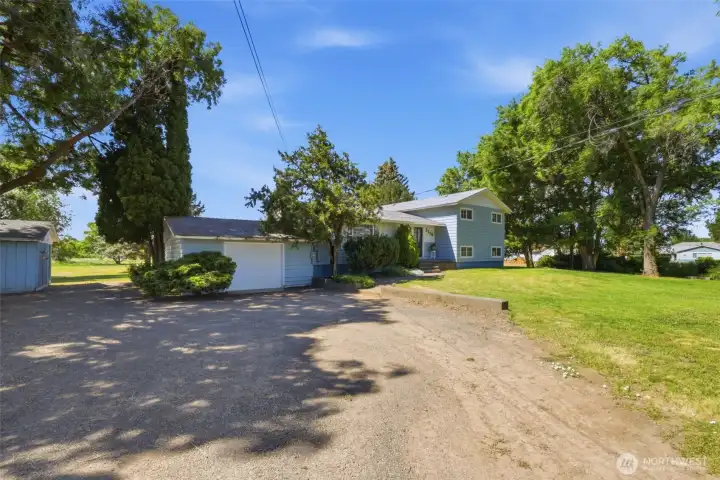 Front driveway of the home. A single car garage is attached to the home and there is lots of covered parking if desired in the massive shop. Front driveway of the home. A single car garage is attached to the home and there is lots of covered parking if desired in the massive shop.